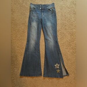 Flared jeans with sew on silver beaded stars. New without tags. Size 28 / 9